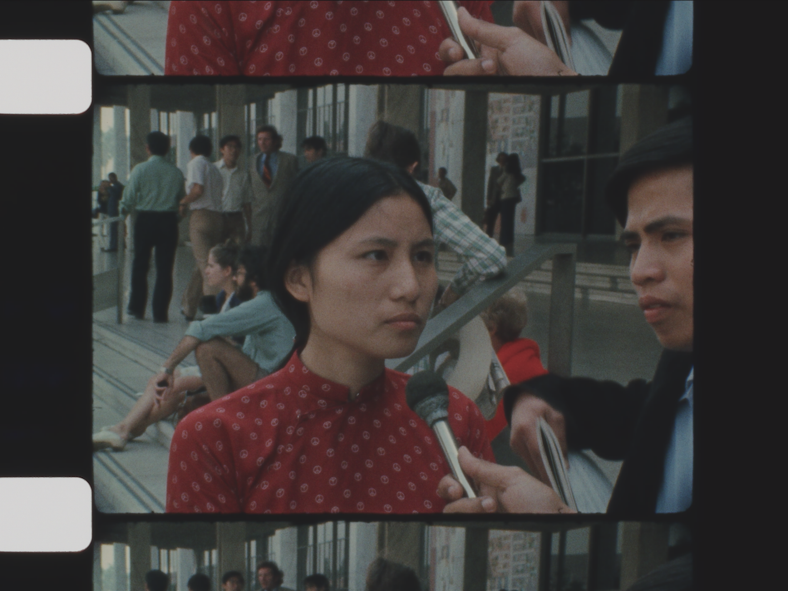 A woman being interviewed in front of a building.