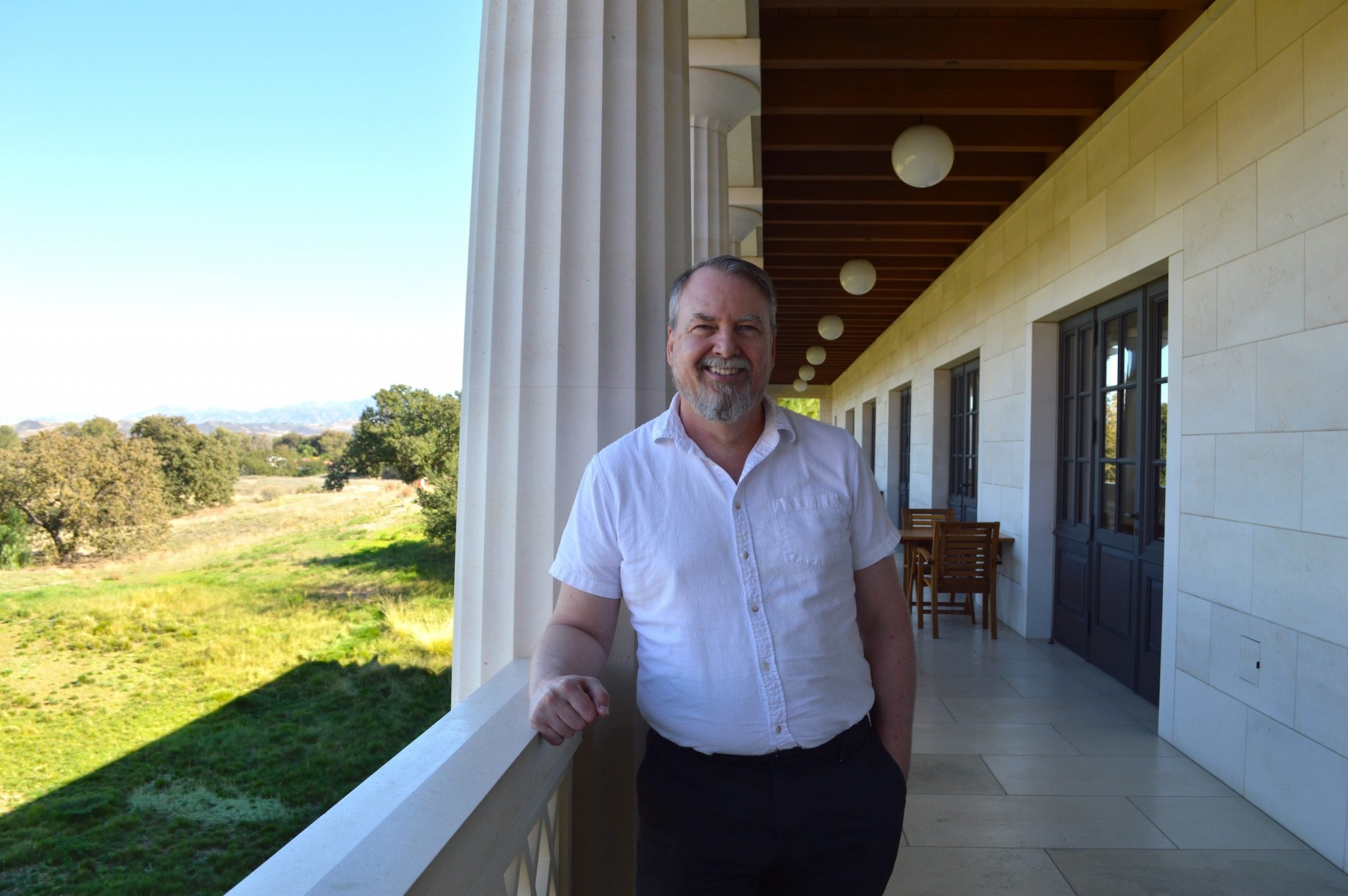 Jeff Bickel smiling on a balcony.