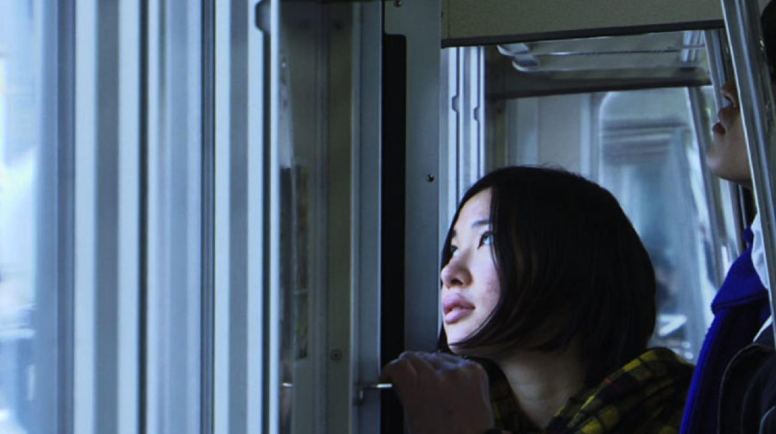 a woman looking out the window on a train