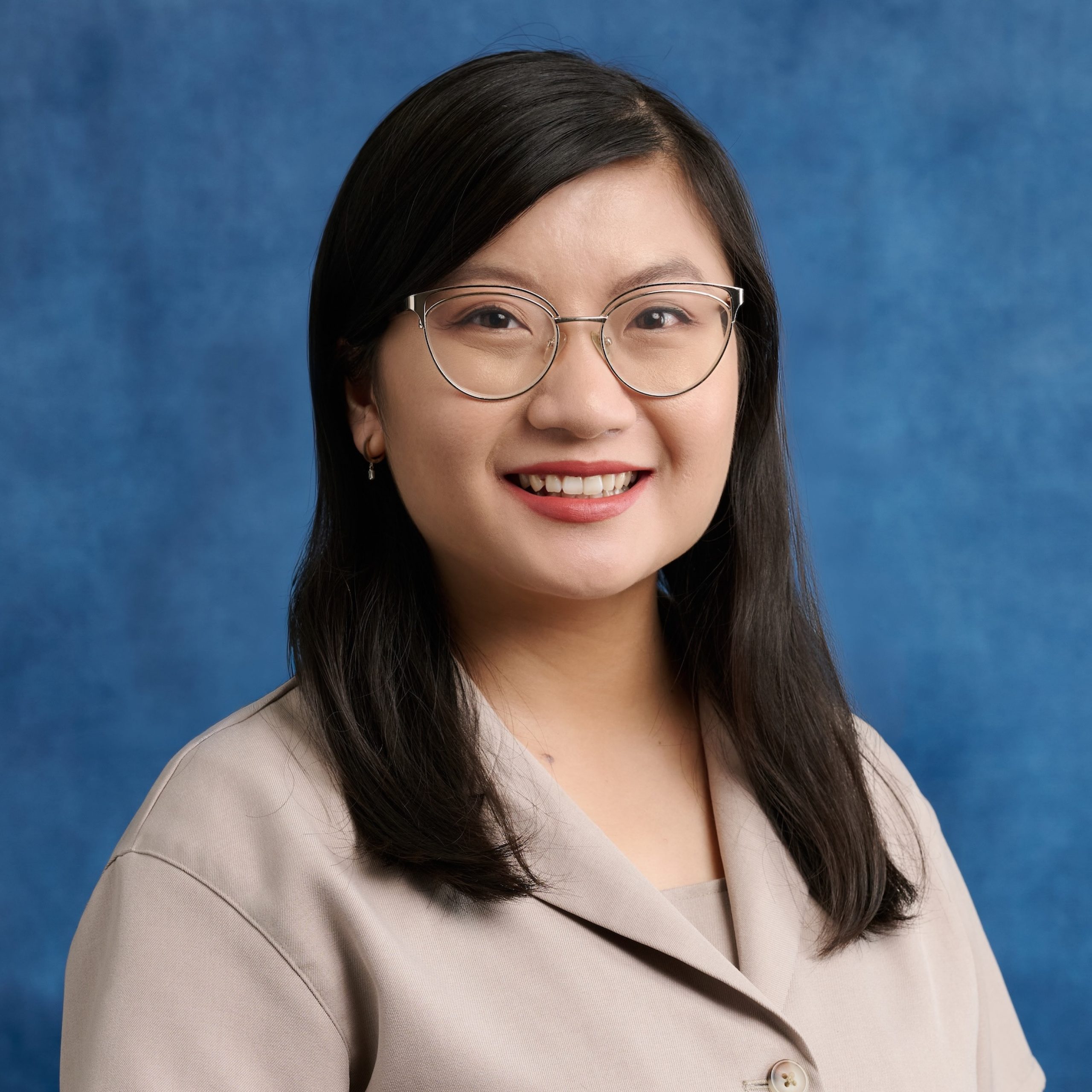 Michelle Li headshot wearing glasses and collared light brown top