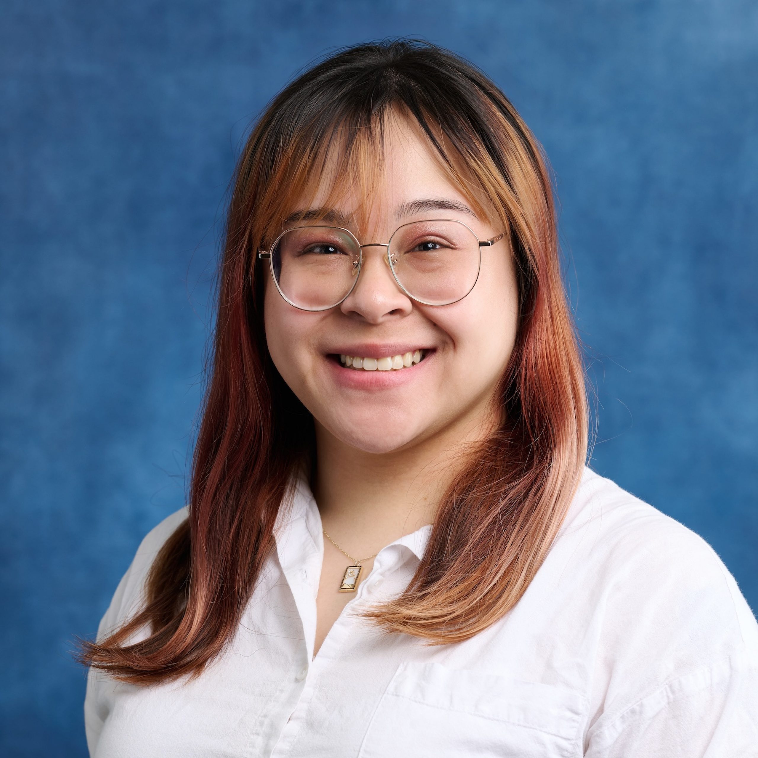 Savannah Dawson headshot wearing glasses and white collared top