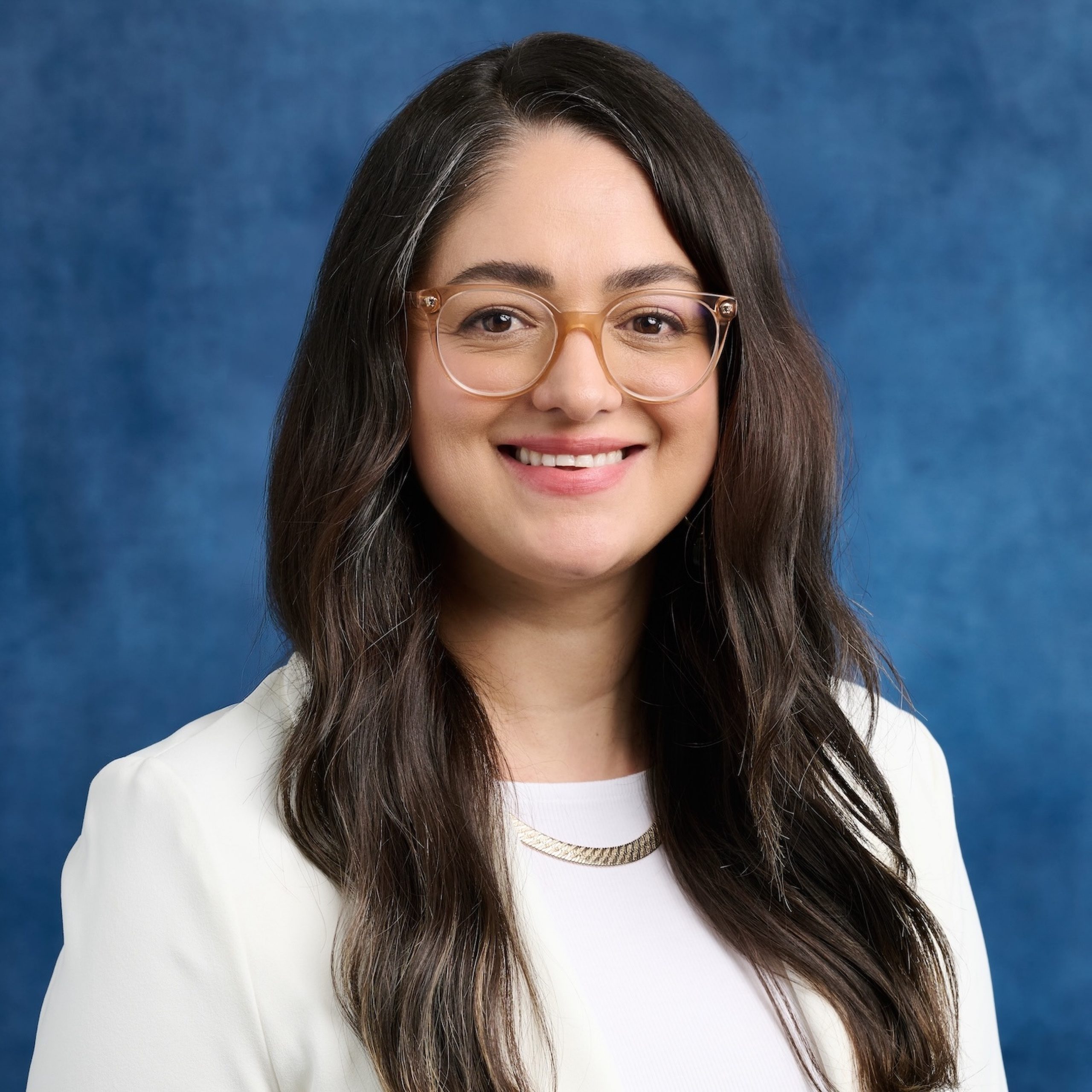 Lilia Valdez headshot wearing white blazer and top