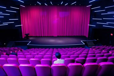 Billy Wilder Theater interior with one person sitting in the audience.