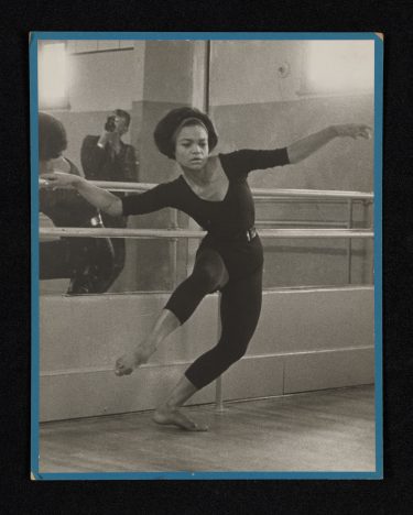 Black and white photography of dancer Eartha Kitt with Howard Morehead reflected in a mirror behind her.