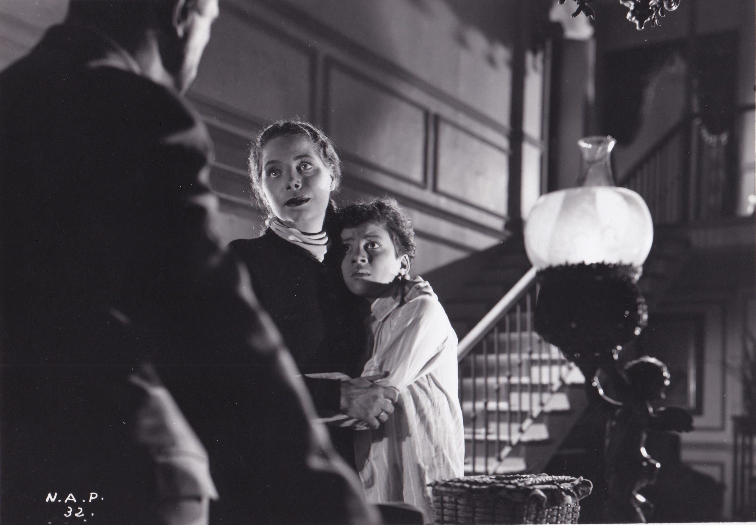 Woman holding a frightened looking boy