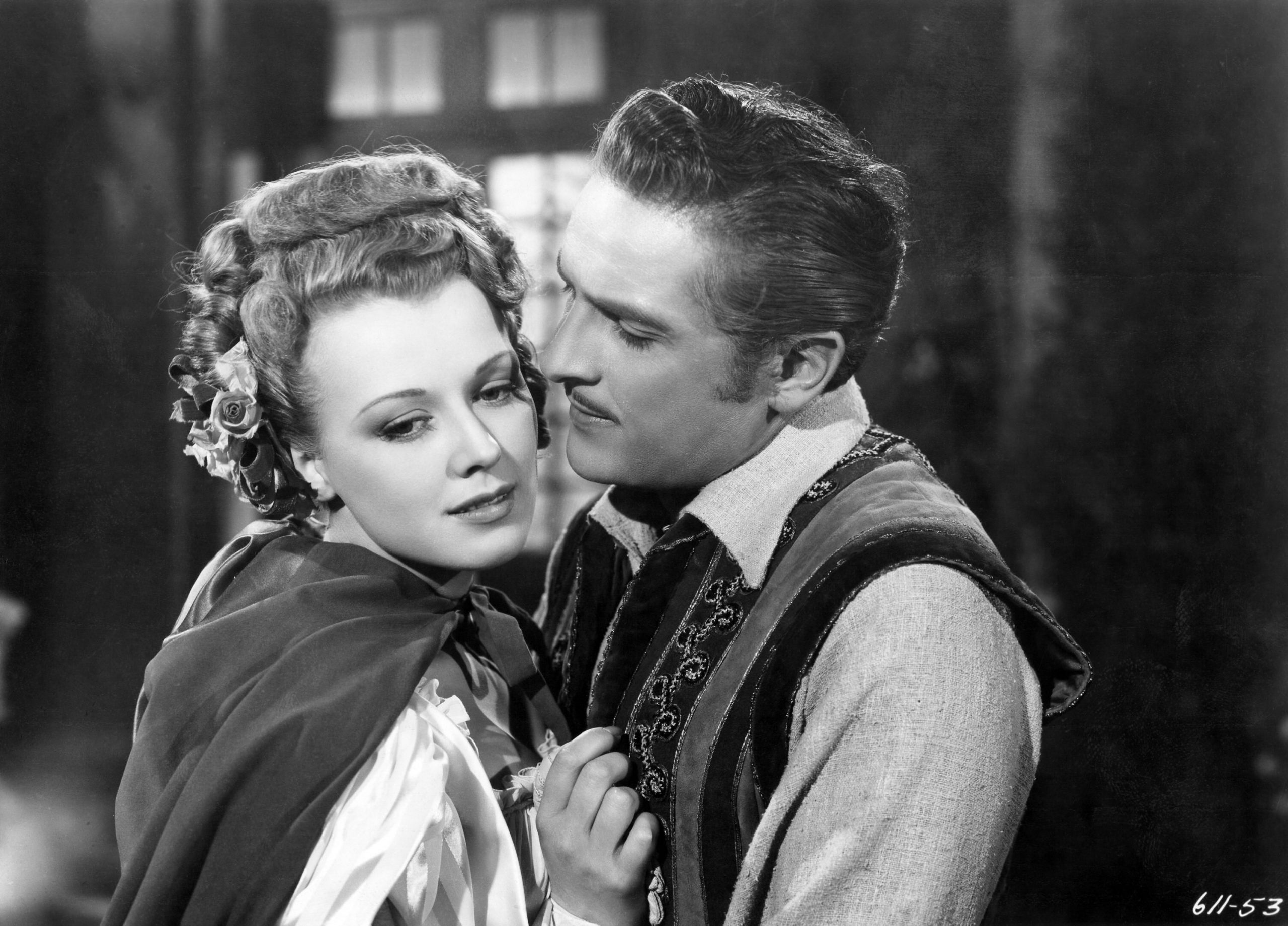 man embracing woman in still from Adventures of Casanova