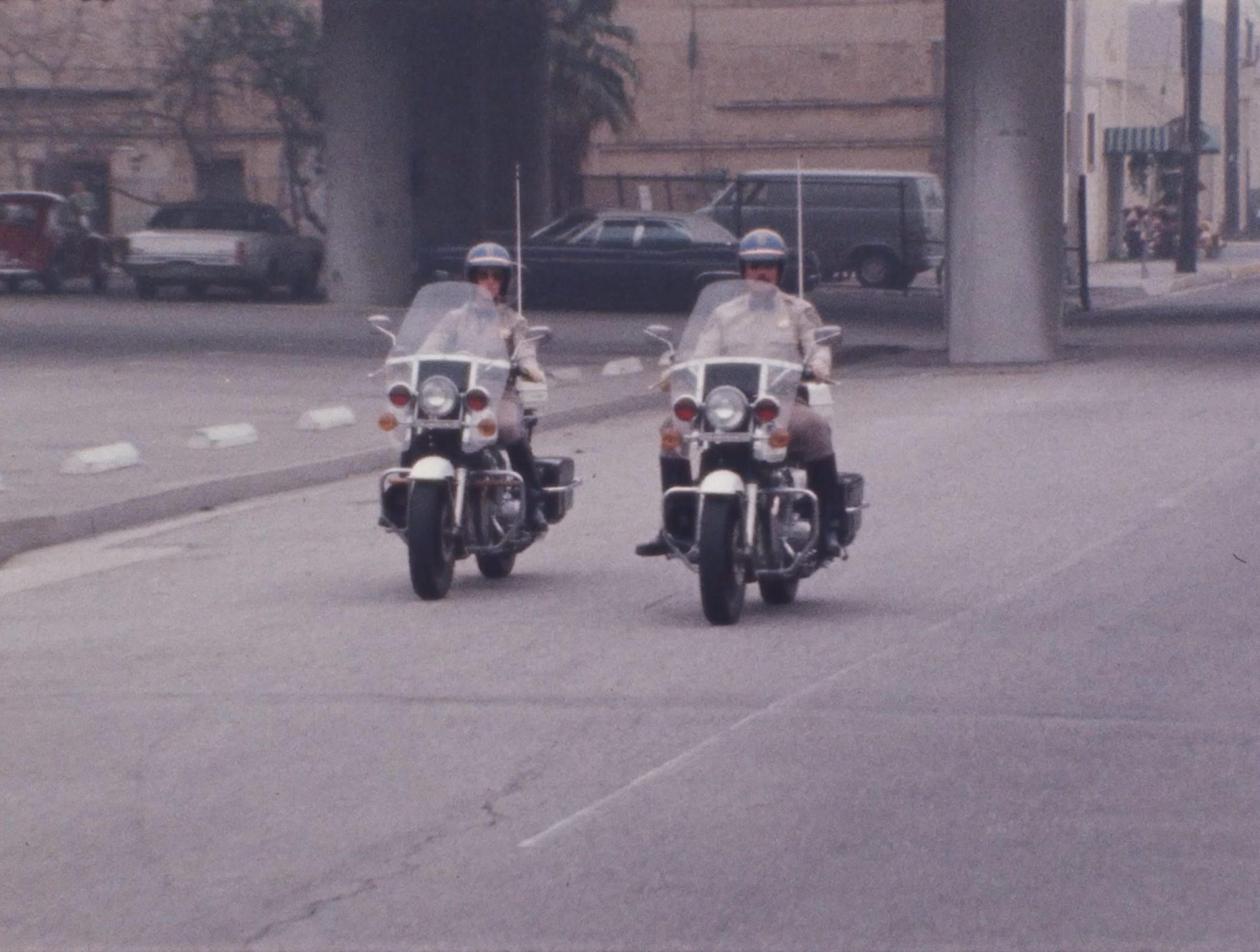 Two California Highway Patrol officers on motorcycles.