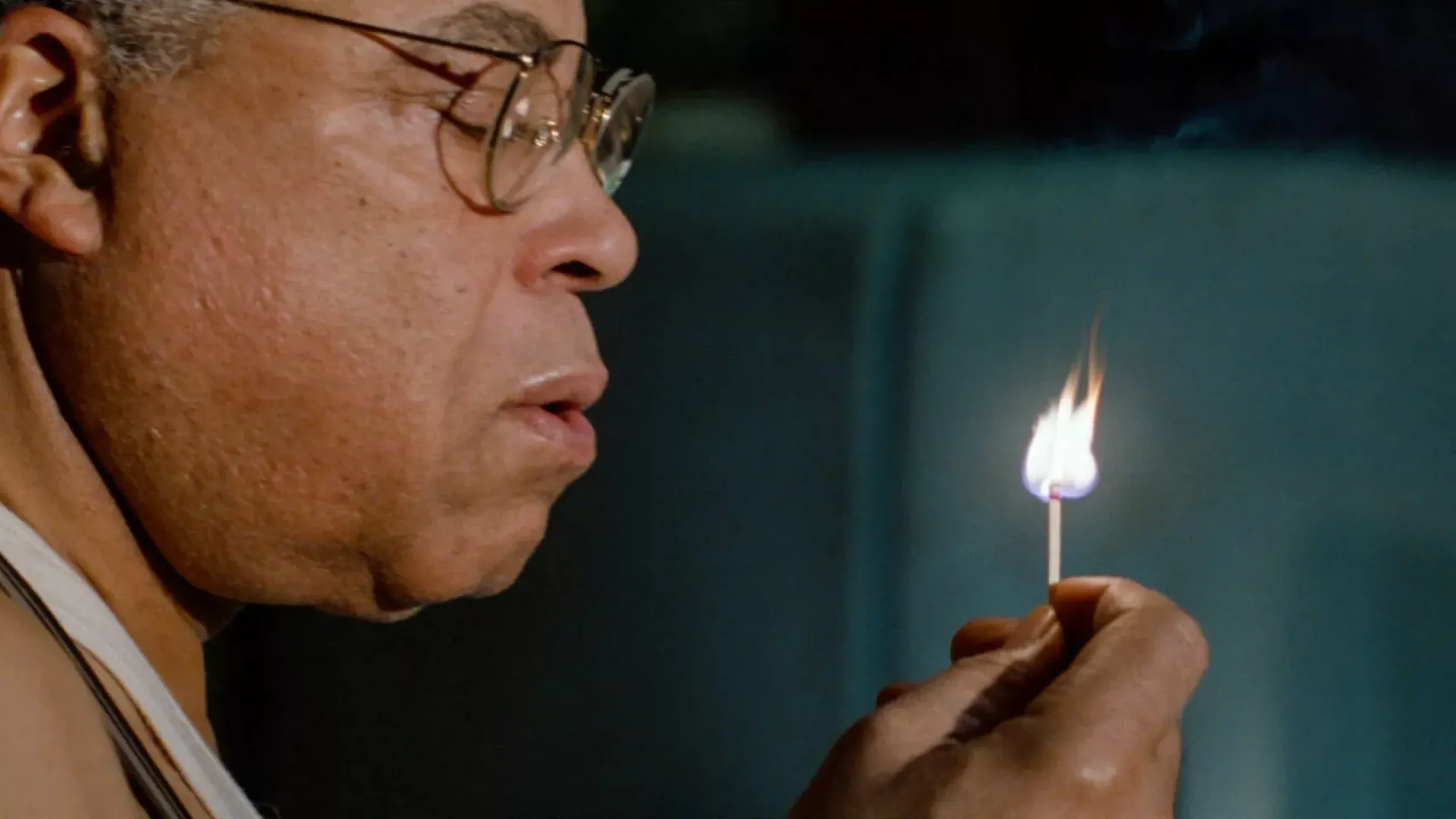 man blowing out a match