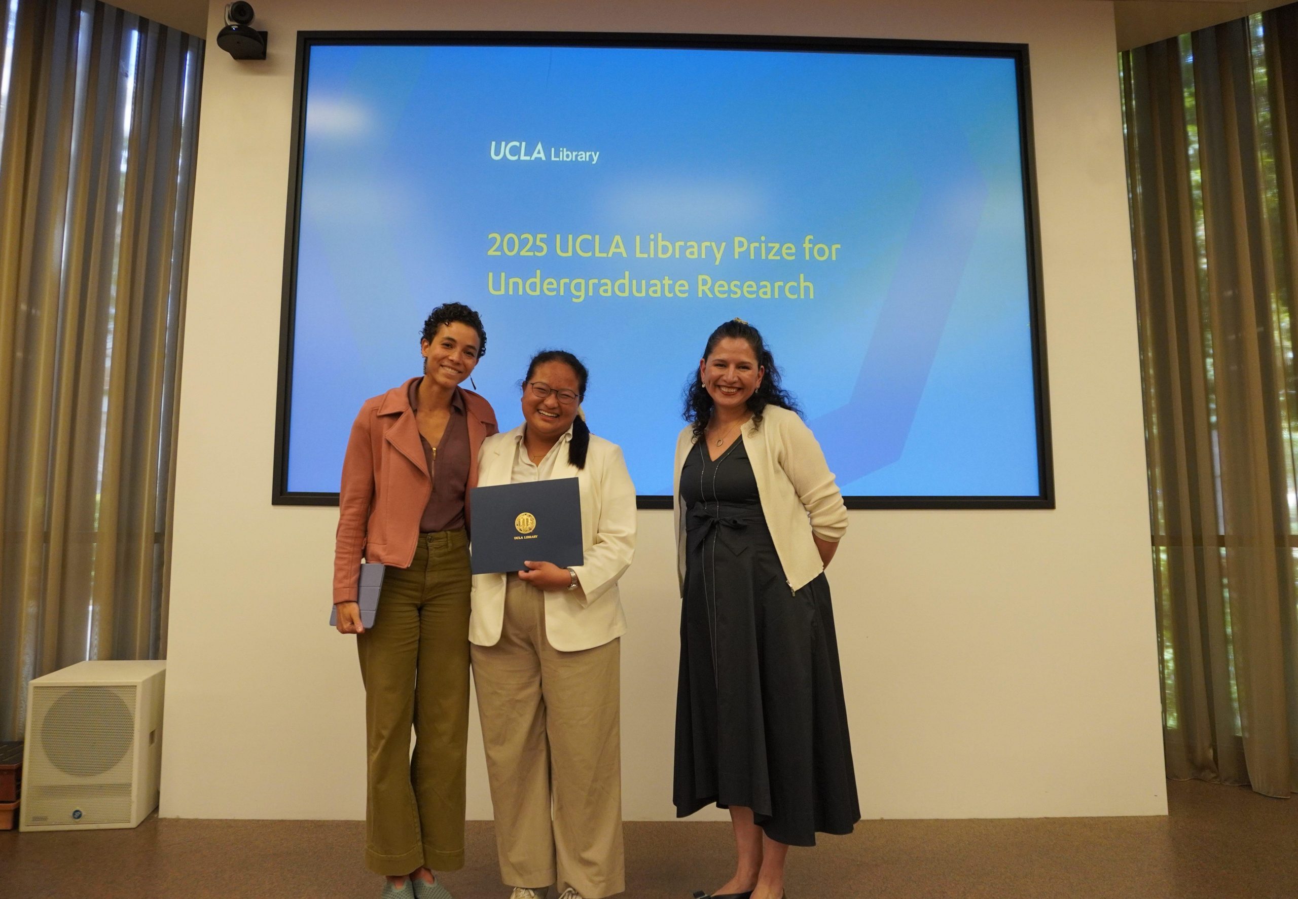 Kaily Heitz, Chanaporn Tohsuwanwanich, Athena Jackson standing in front of a presentation screen