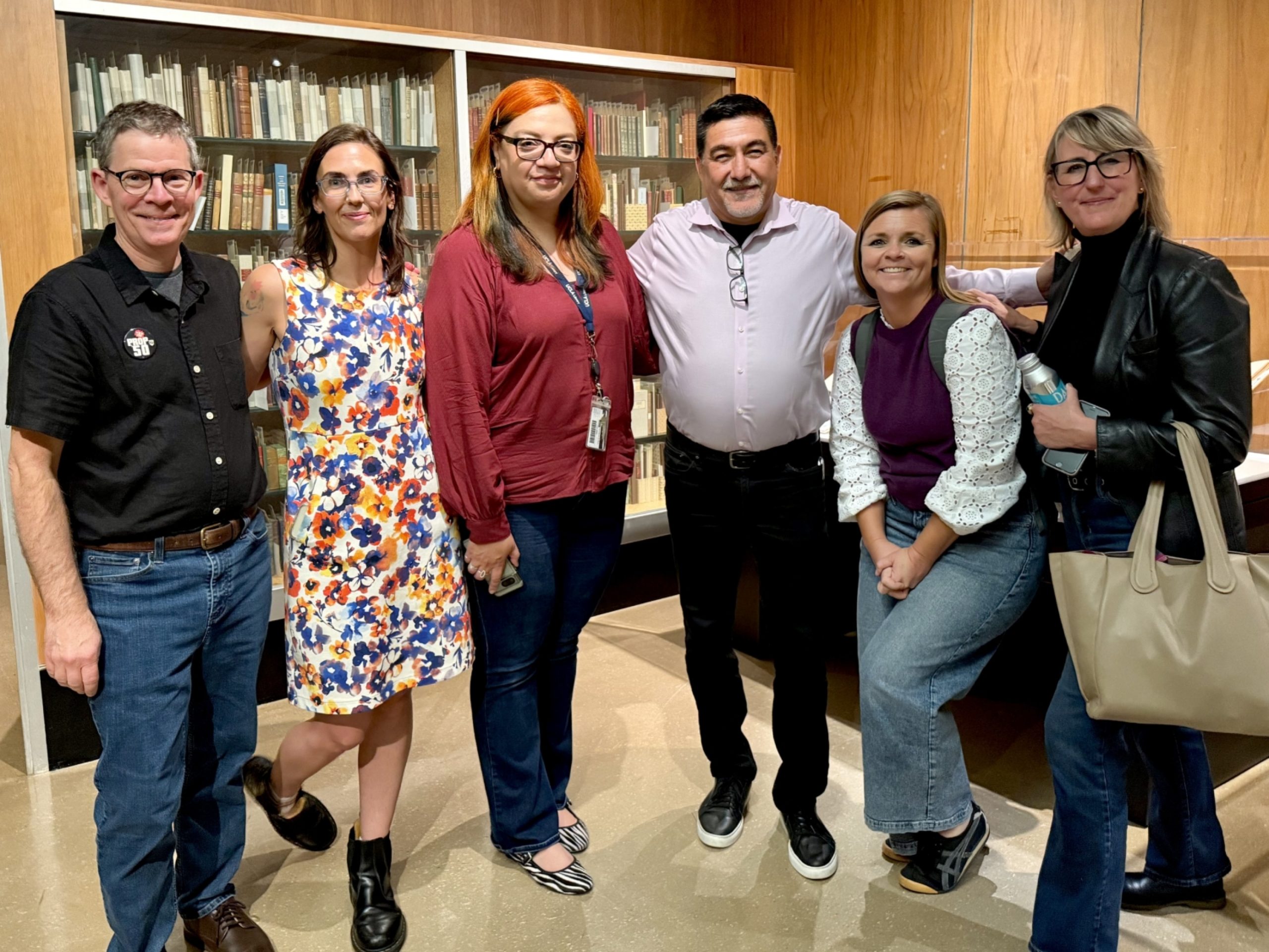 UCLA IRLE and UCLA Library staff pose with David Huerta in UCLA Library Special Collections