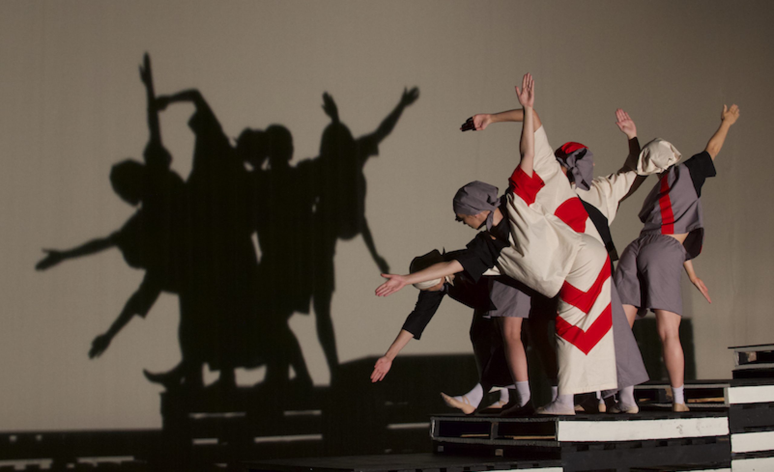 women holding their arms in bent poses while doing acrobatic movements