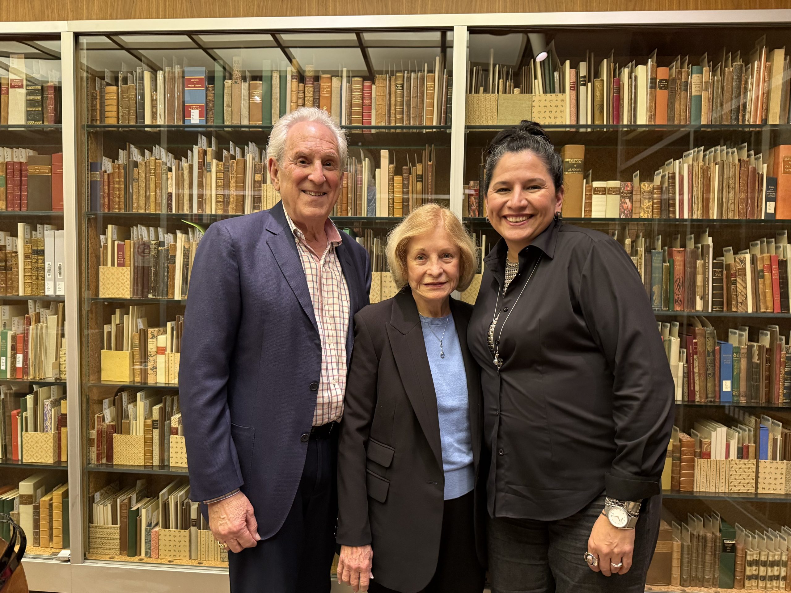Photo of Harry Lederman, Sandy Gooch, and University Librarian, Athena N. Jackson inside UCLA Library Special Collections.