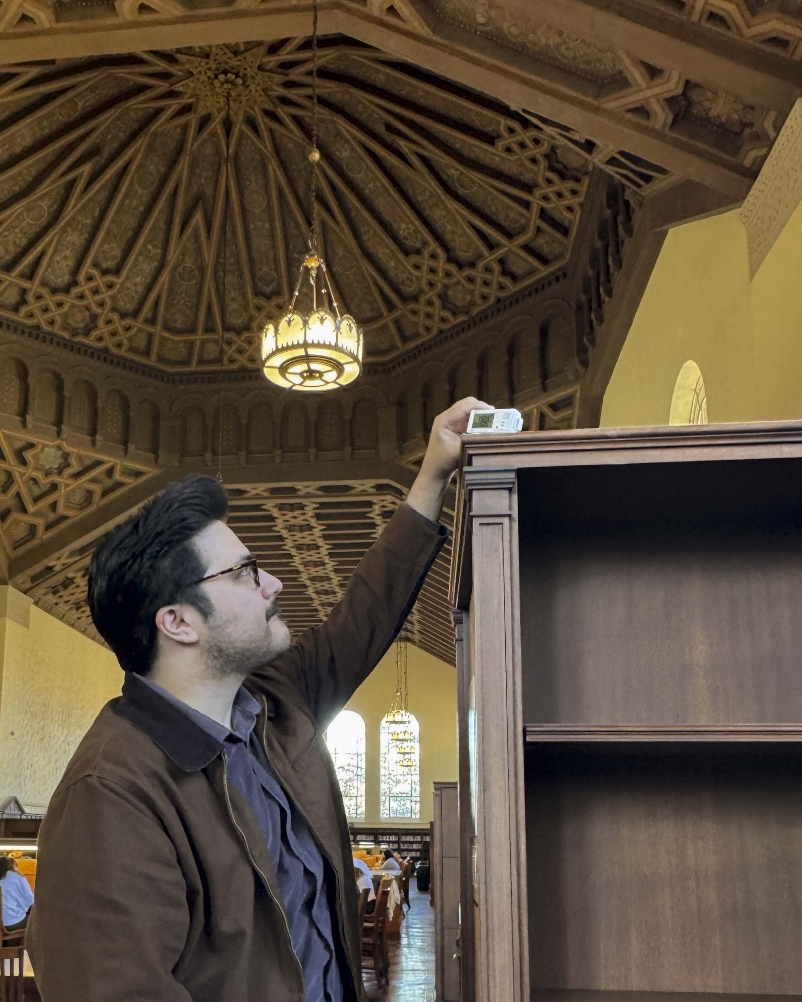 Ryan Interrante checks data logger at Powell Library