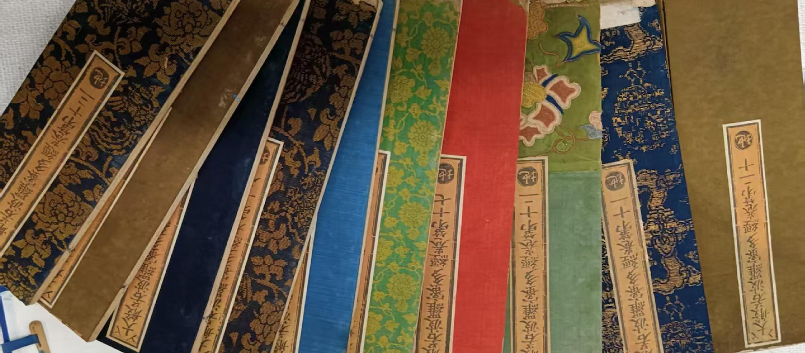 various Buddhist texts fanned in a row