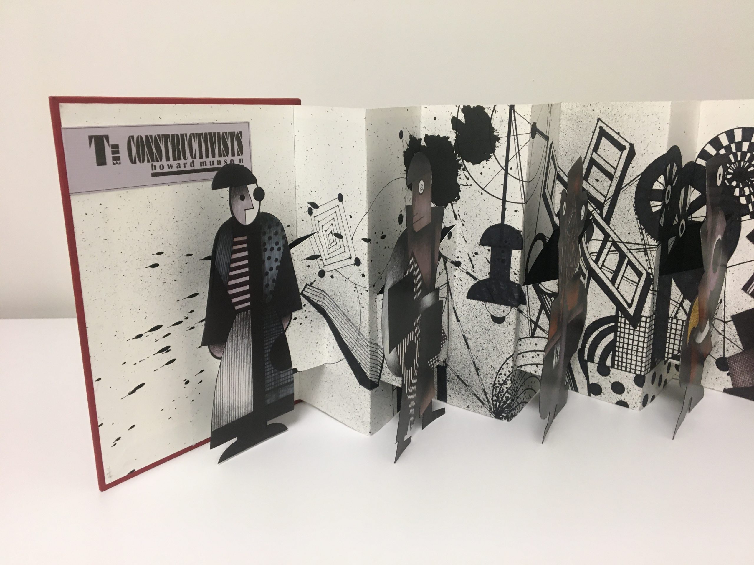 closeup of accordian fold artist book with cutout figures
