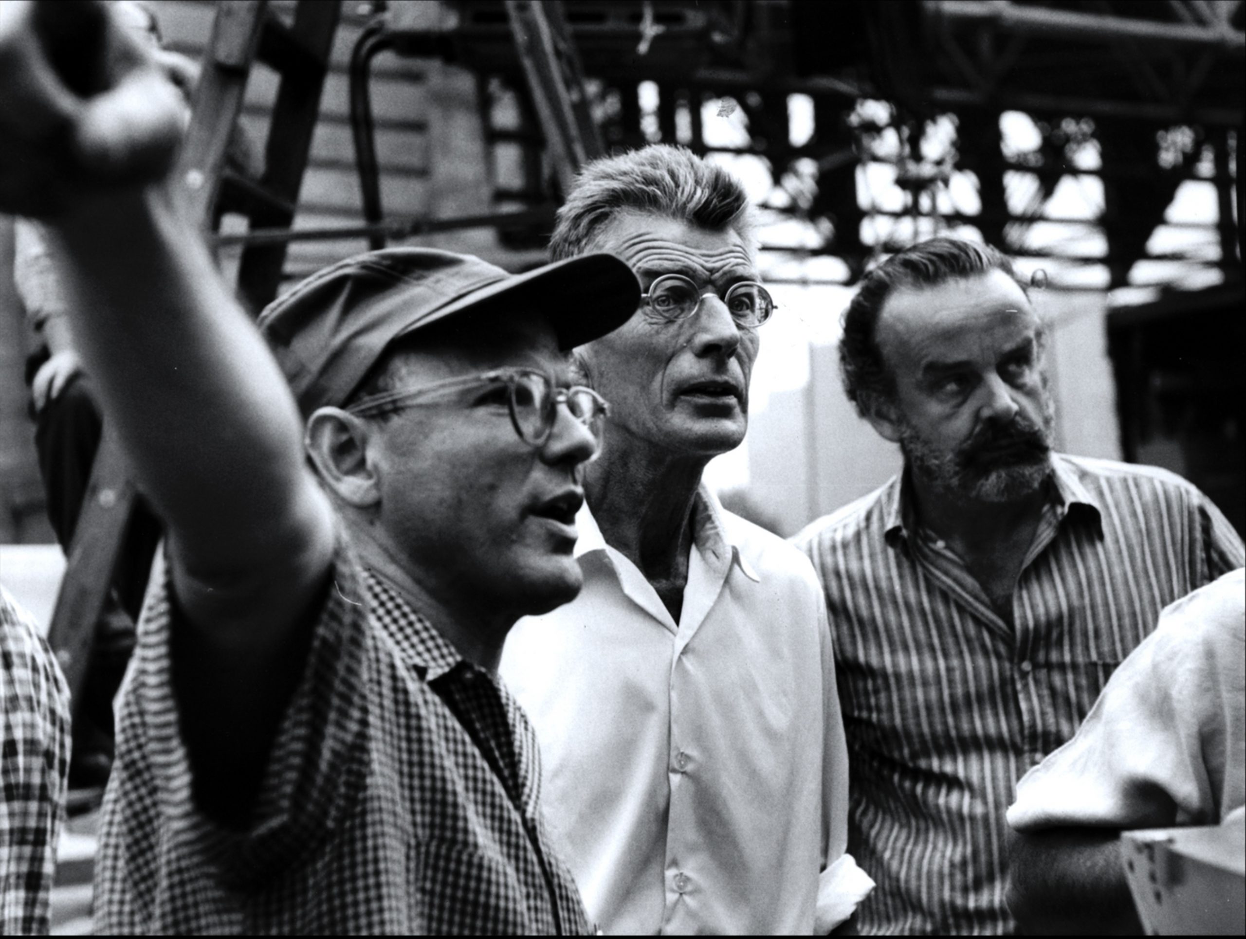 A black and white image of three men working on something