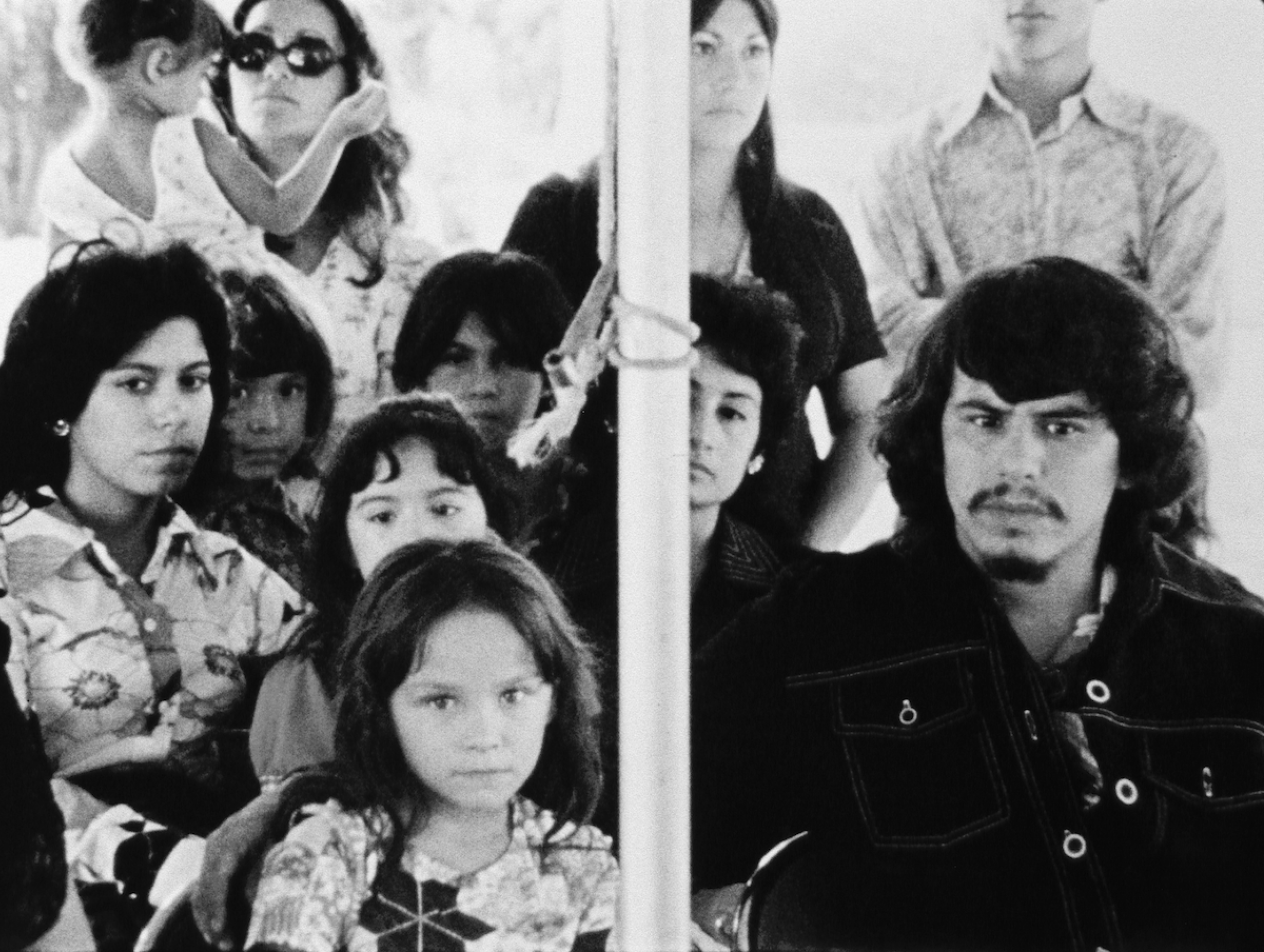 group of men, women and children looking forward to the camera
