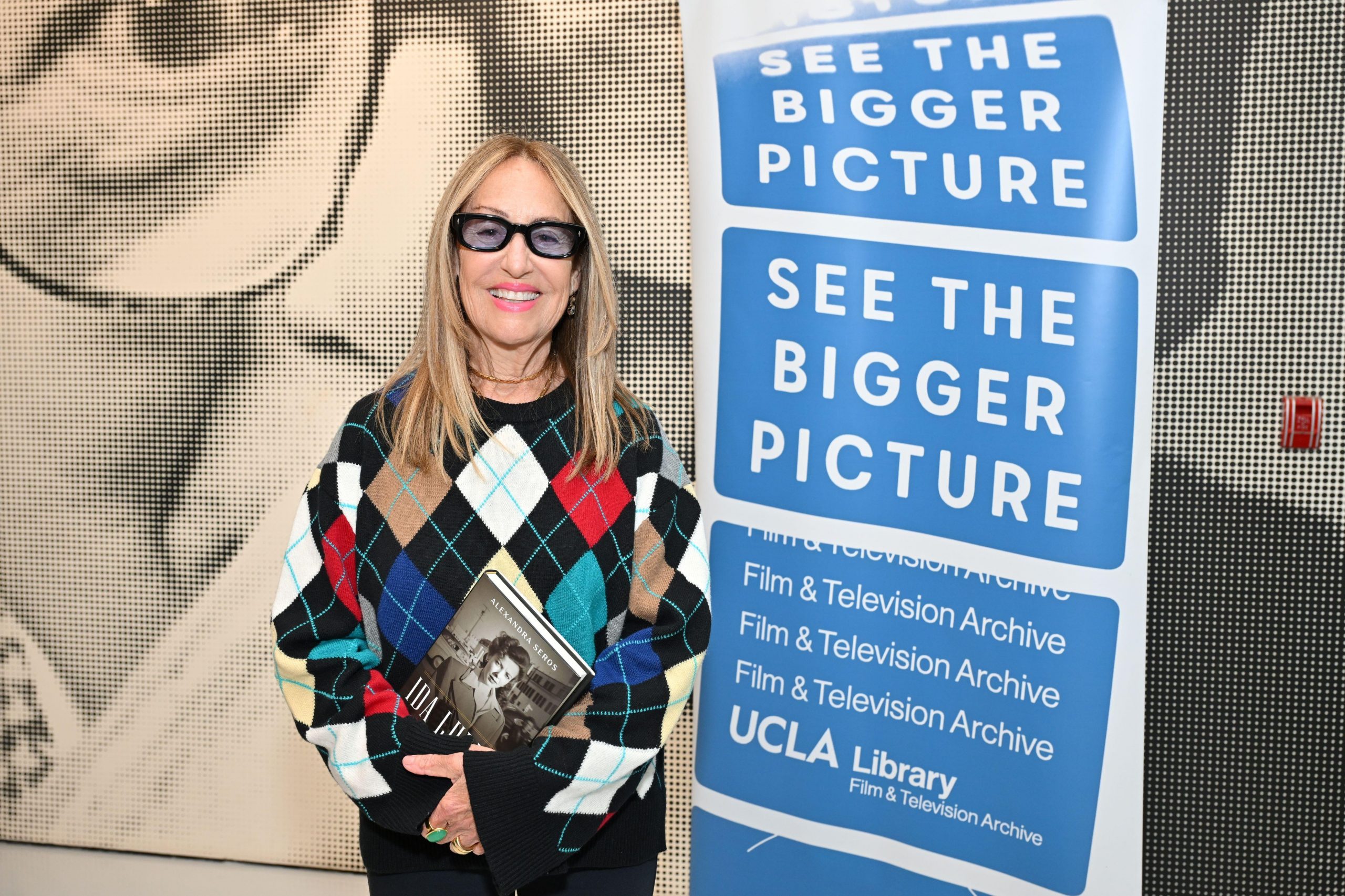 Alexandra Seros at Billy Wilder Theater in front of event banner.