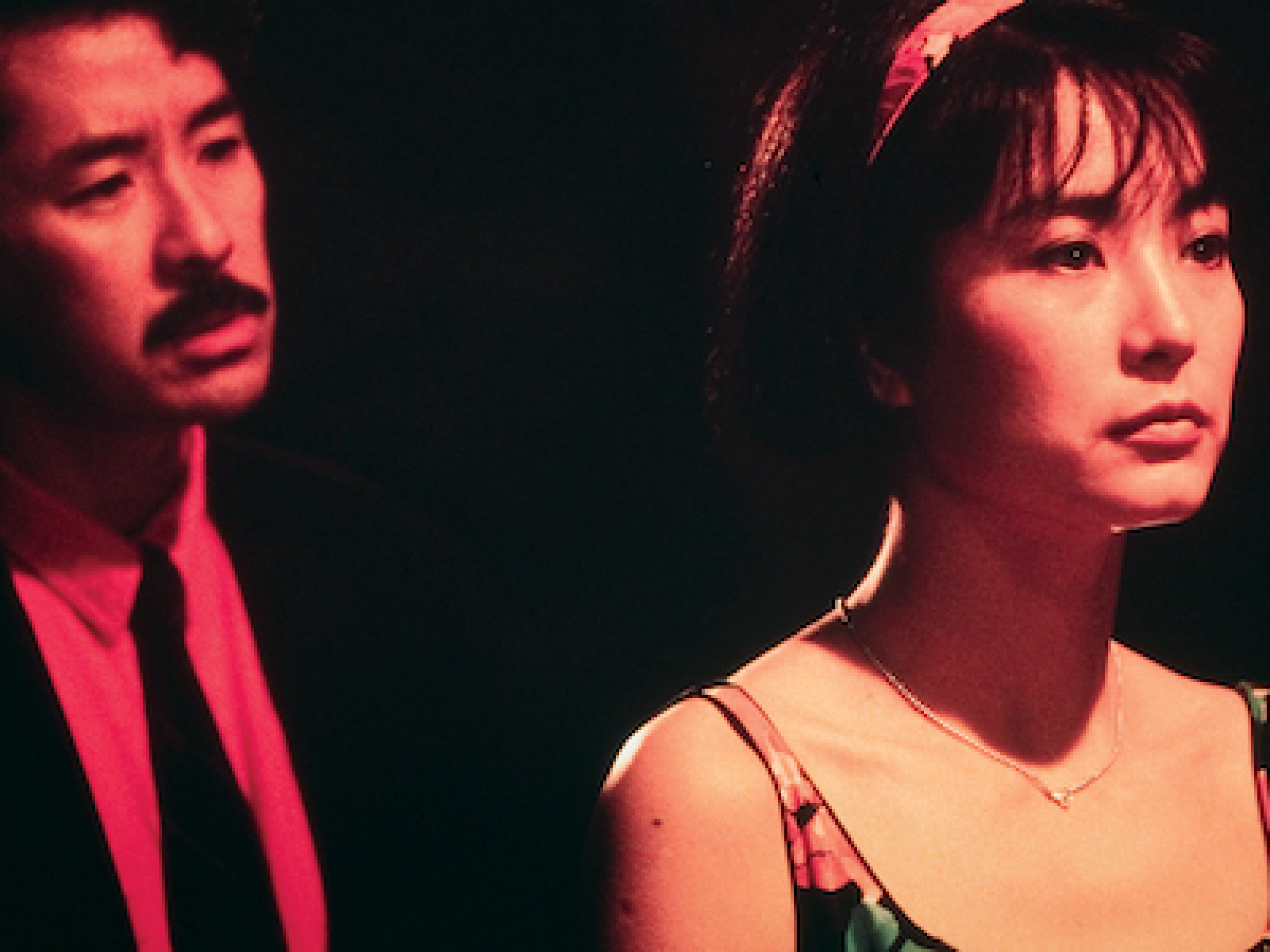 man standing behind a woman