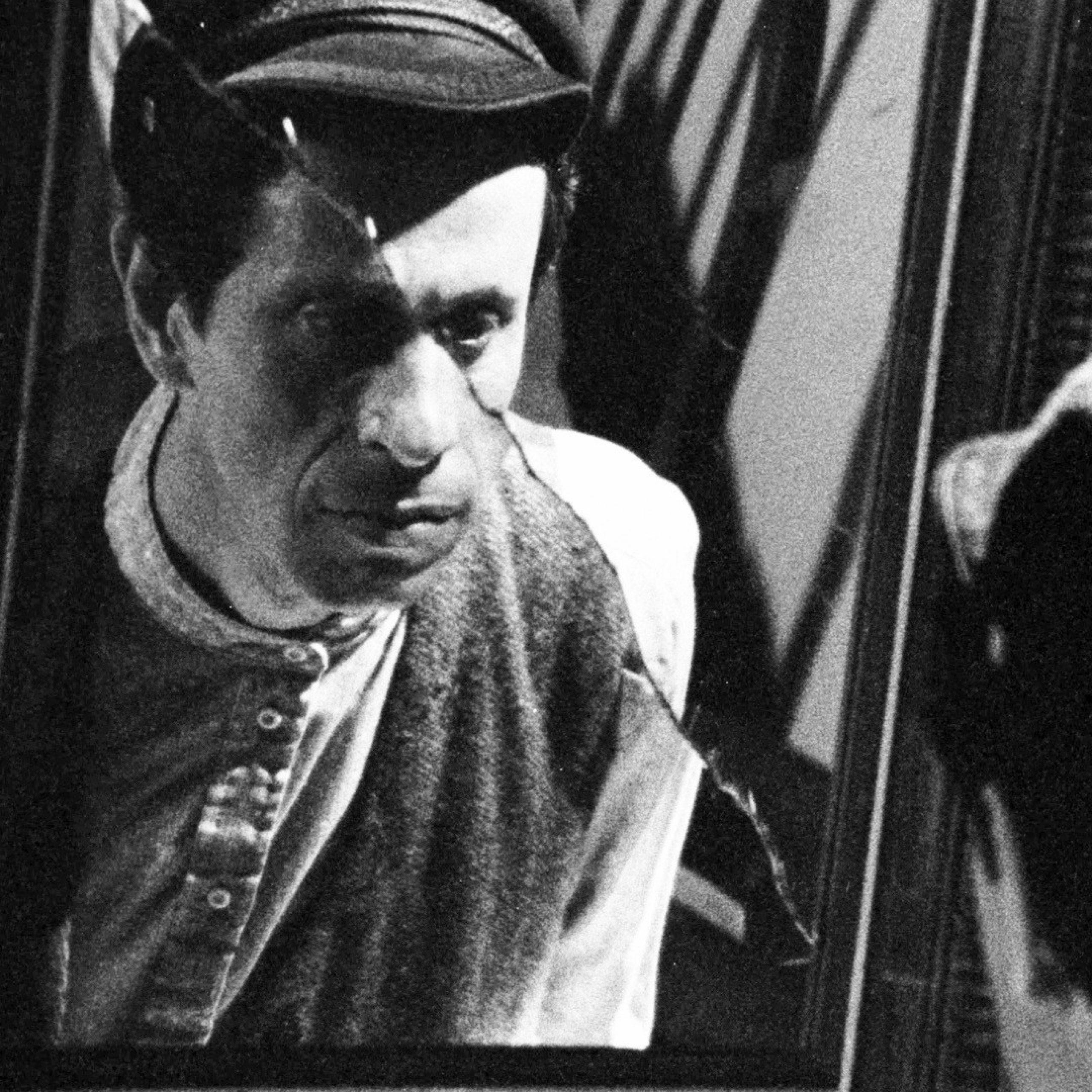 A man looking into a broken mirror