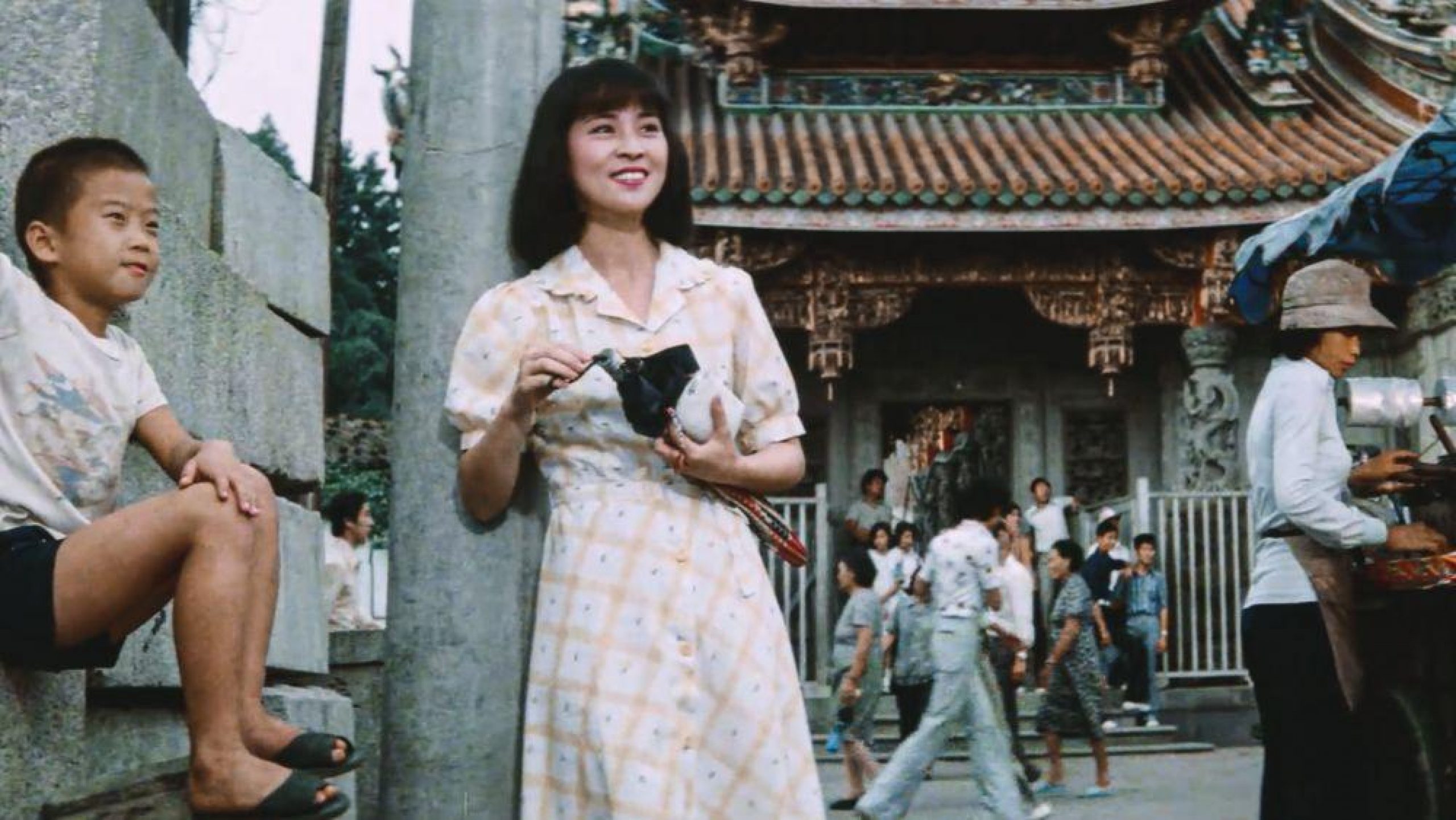 woman standing in street with traditional asian building in background