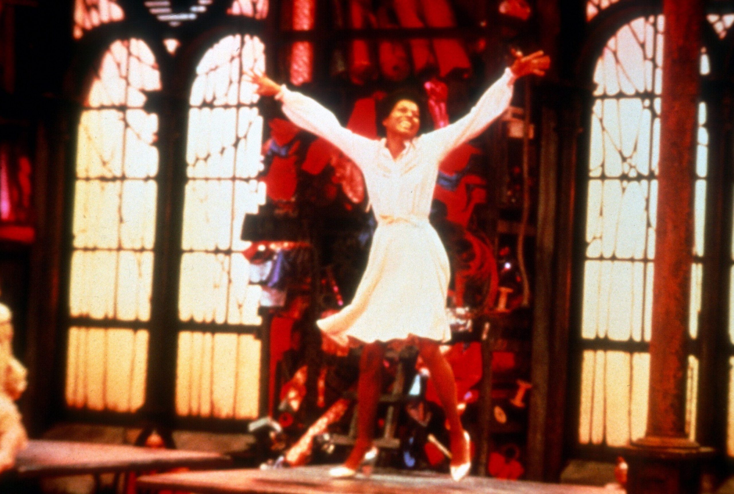 A woman dancing and singing on stage