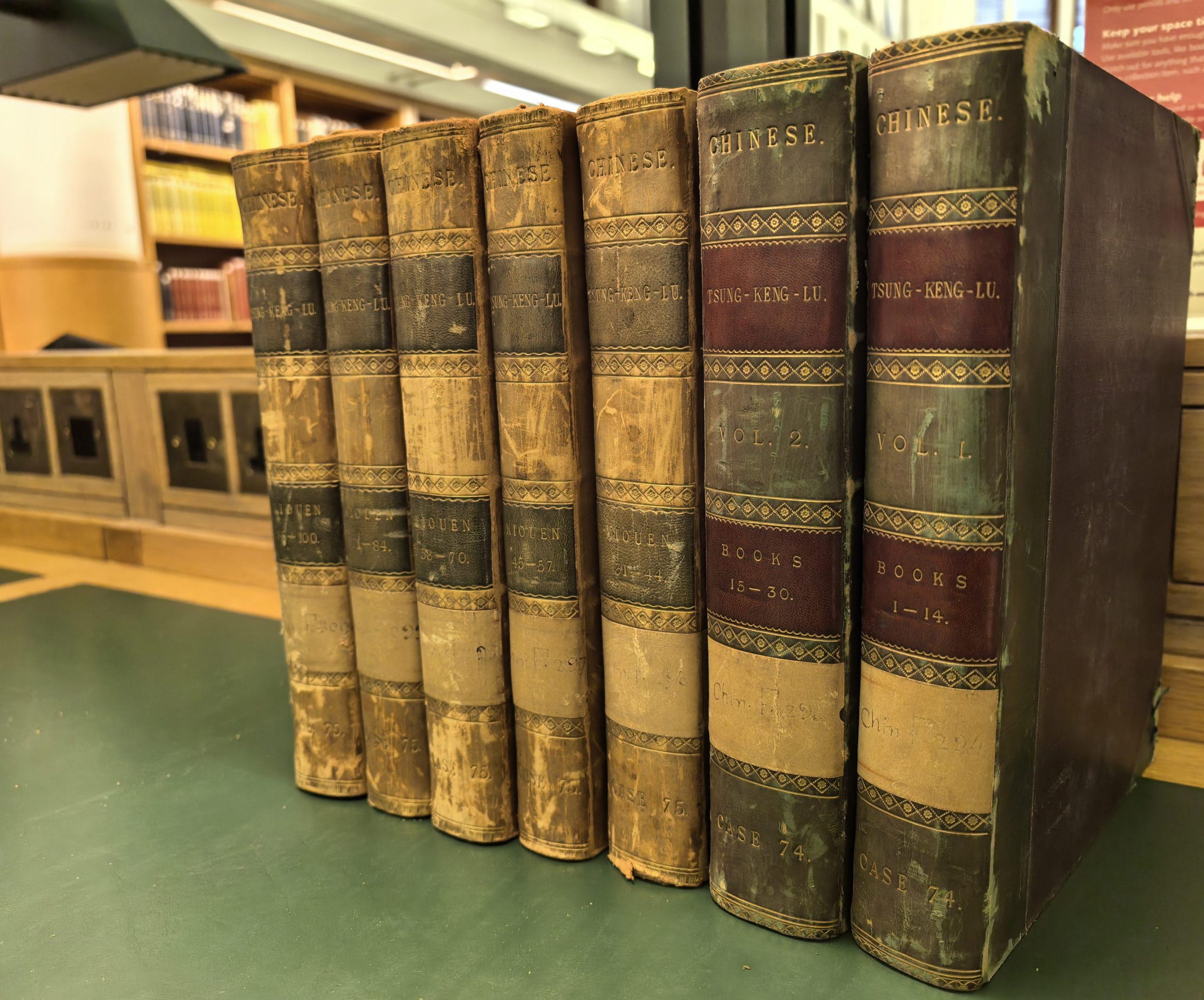 row of old book volumes stood up in a row