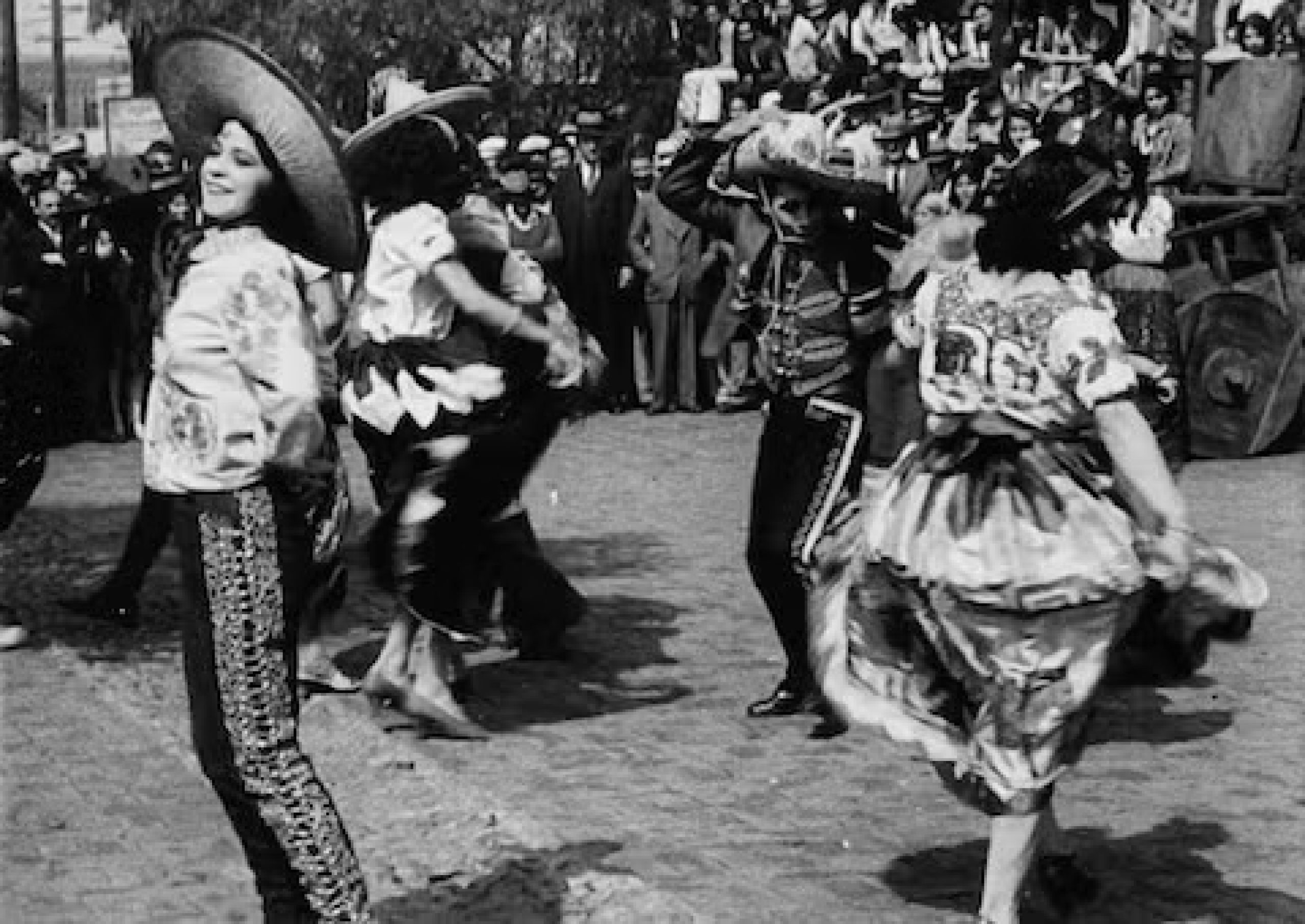 black and white image of mexican dancers wearing traditional garb