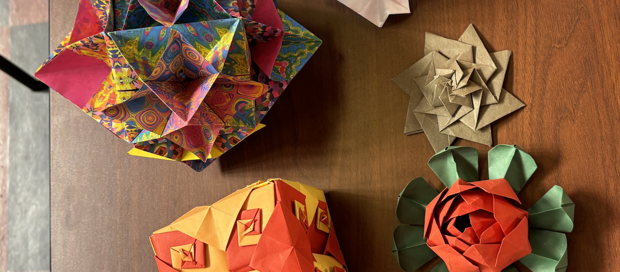 folded origami shapes of cube and rose