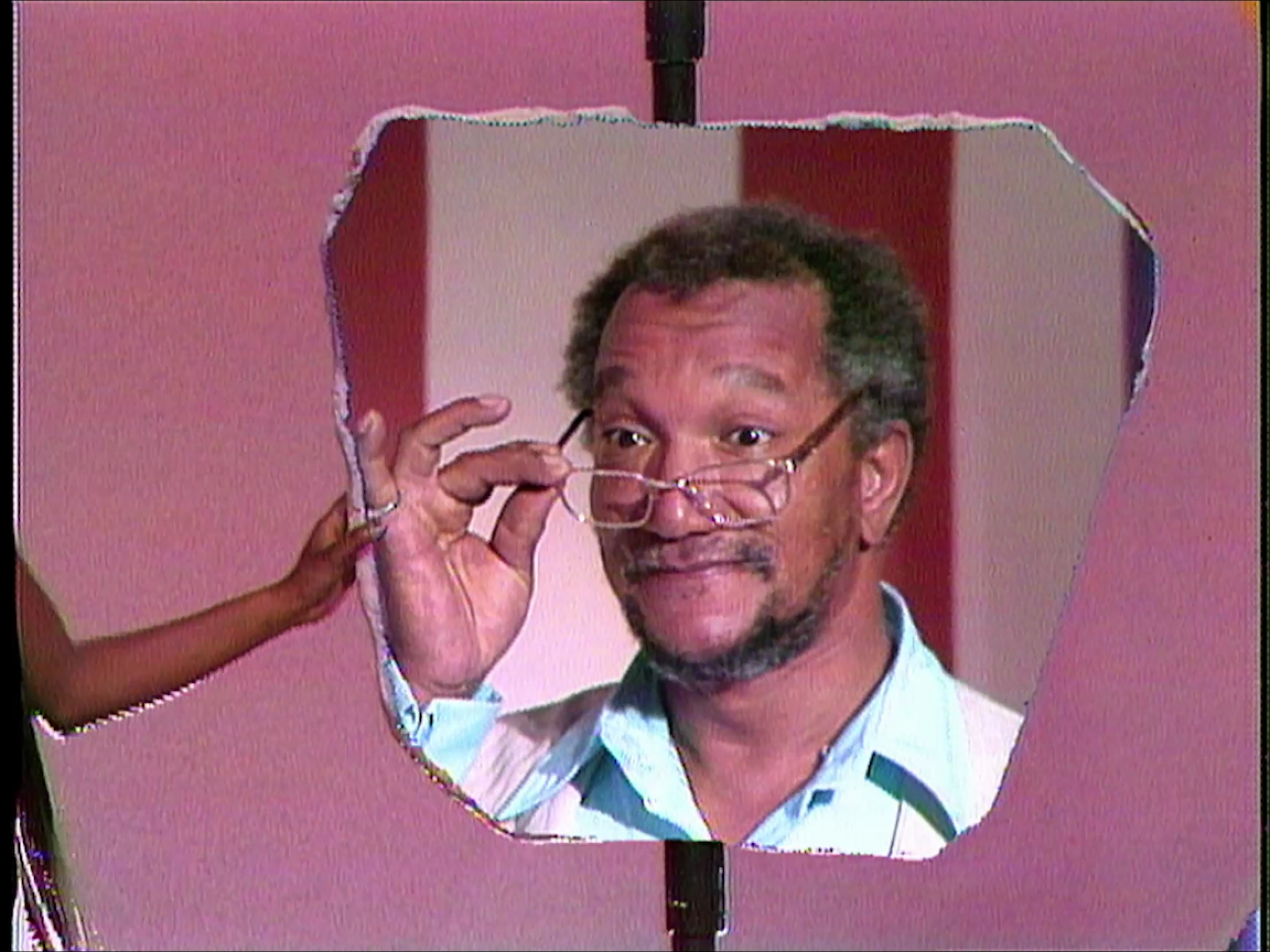 Actor Redd Fox peering over his glasses