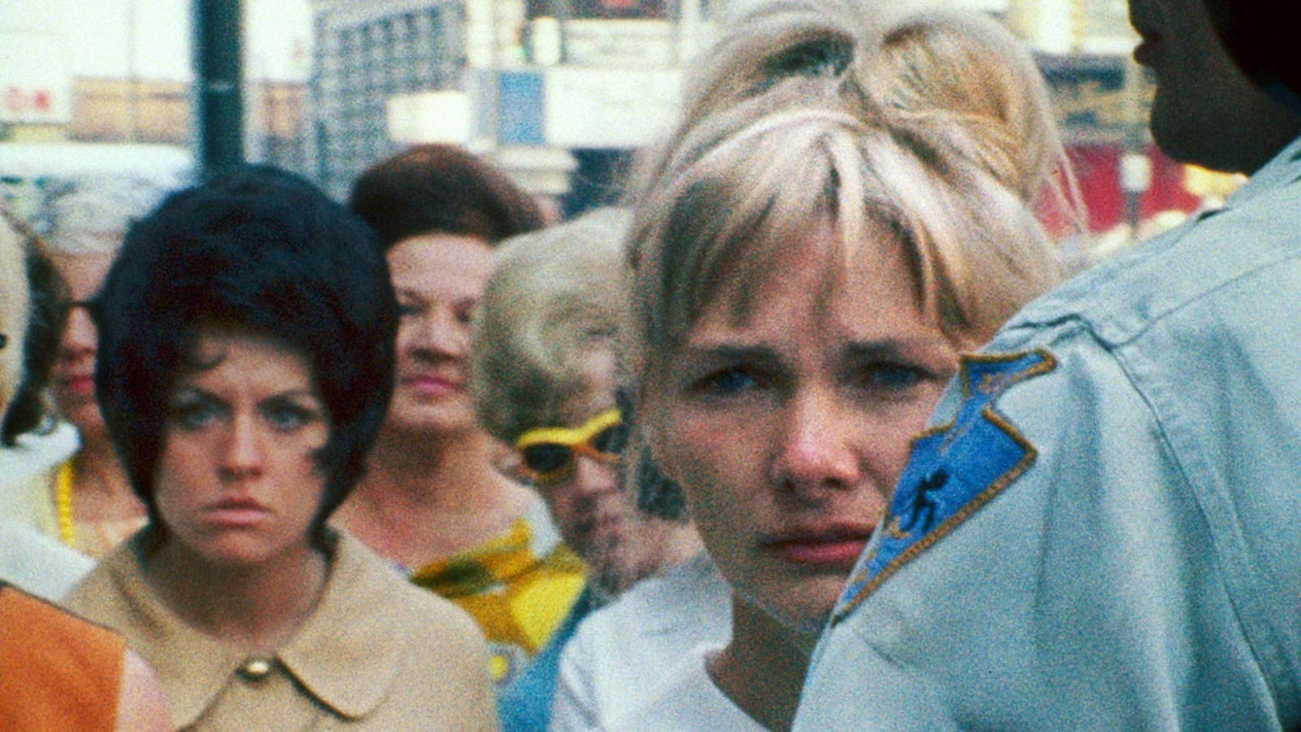 Close up of woman's face in a crowd of faces